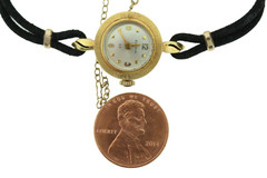 18K gold BULOVA M7 ladies wrist watch on silk cord.