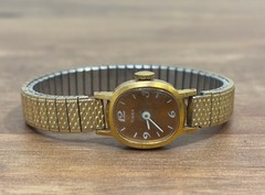 Timex Gold Tone Oval Analog Women’s Wristwatch Orange/Brown Dial Gold Band