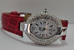 Nolan Miller women’s watch with oval silver-tone crystal case & red leather band