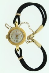 18K gold BULOVA M7 ladies wrist watch on silk cord.