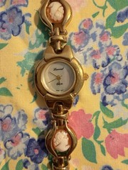 Lucoral gold-tone wristwatch w cameo portrait links and a Japan quartz movement.