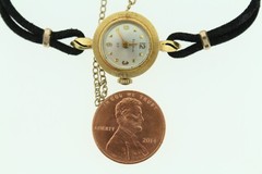 18K gold BULOVA M7 ladies wrist watch on silk cord.