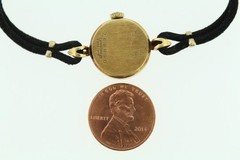 18K gold BULOVA M7 ladies wrist watch on silk cord.