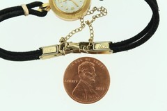 18K gold BULOVA M7 ladies wrist watch on silk cord.