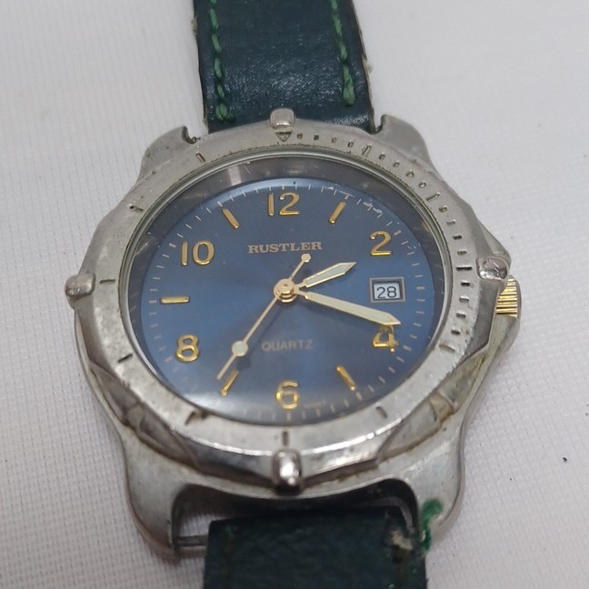 Rustler Quartz Analog Wristwatch Blue Dial Date Silver Case Green Leather Strap