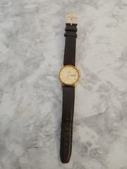 vintage gold-toned Titan Classique quartz watch featuring a day and date display