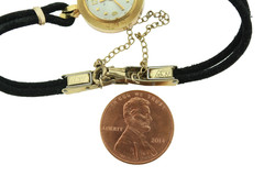 18K gold BULOVA M7 ladies wrist watch on silk cord.